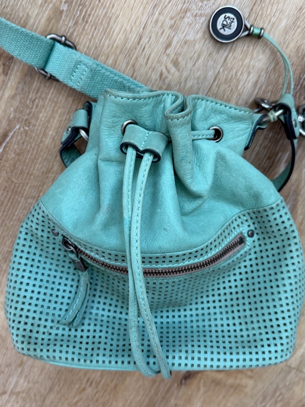 The Sak Mint Green Perforated Drawstring Crossbody Bag
